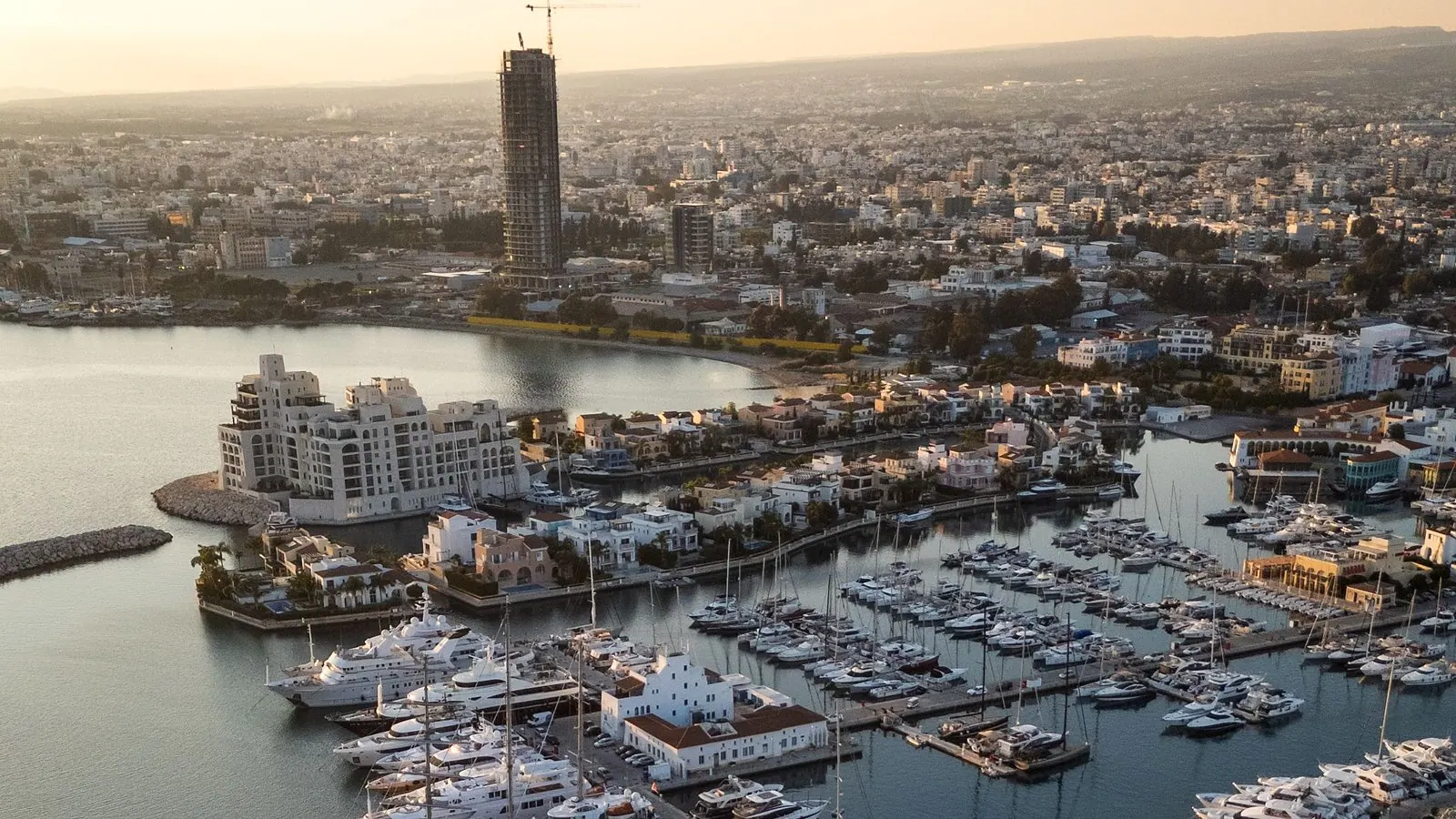 Limassol marina at sunset, aerial view of superyachts and the city skyline